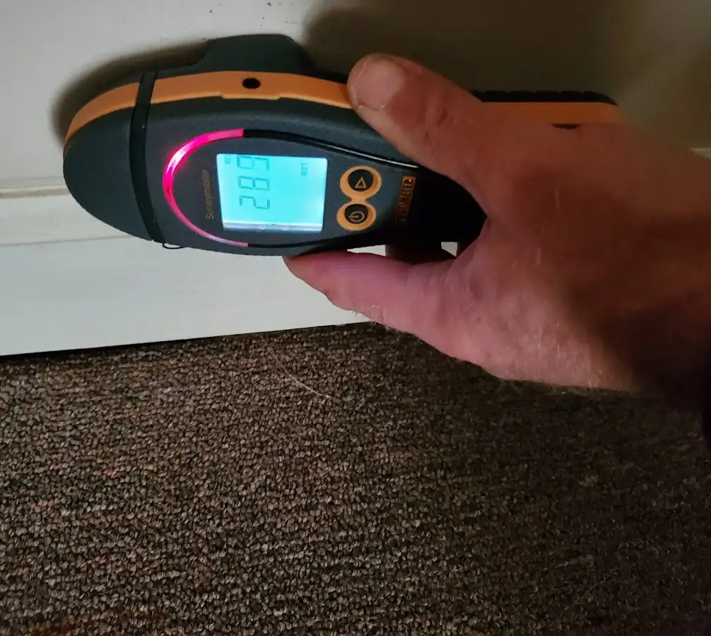Moisture detection at baseboard during Storm Damage Restoration in Madera